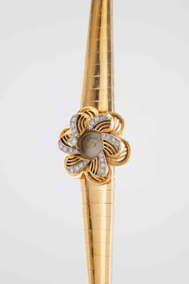 an image of a close up of a gold and diamond watch