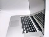 a silver laptop computer sitting on a white surface