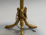 a small table with a lamp on it and a chain around the base