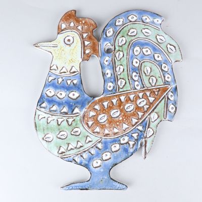 a ceramic sculpture of a rooster on a white surface