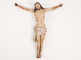 a wooden statue of jesus on the cross on a white background