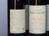 several bottles of wine are lined up on a table