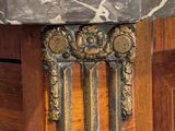 a close up of a marble top on a wooden cabinet
