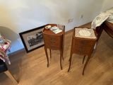 two small tables that are next to each other on the floor