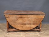 an old wooden table with a wooden top on a wooden floor