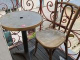 two chairs and a table on the balcony of a building
