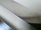 a knife that is sitting on a table next to a knife
