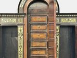 a large wooden cabinet with many drawers on it