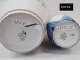 two white vases with blue and white designs on them