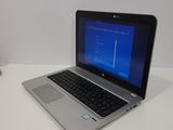 a laptop that is sitting on a table with a mouse