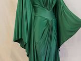 an image of a green draped dress on a mannequin