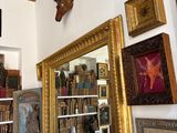 a room with a lot of books and pictures on the wall