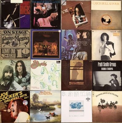 many different album covers on the wall of this room