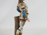 figurine of a man dressed in a suit and boots