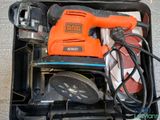 a black and orange electric sander in a black case