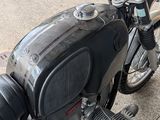 a close up of a motorcycle parked on a sidewalk