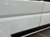 a white van parked in a parking lot next to a building