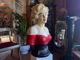 a busturine of a woman in a red dress