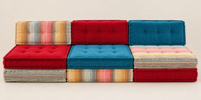 several different colored cushions are stacked on top of each other