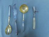 four spoons, a fork, and a knife on a table