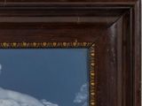 a picture of a white swan in a brown frame