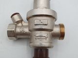 a close up of a metal water pressurer on a white surface