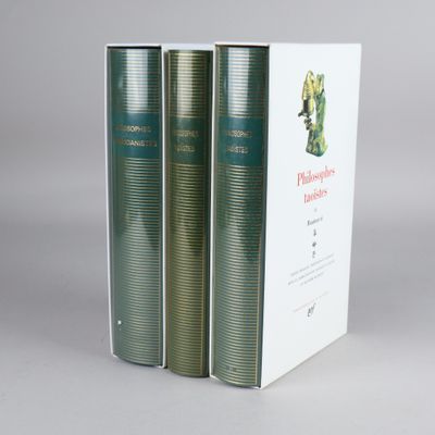 three books are stacked on top of each other on a table