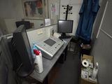 a desk with a computer and a monitor in a room