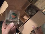 a person holding a glass in front of a box