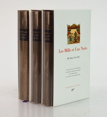 three books sitting on top of a white table next to each other