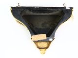 a black and gold piece of paper hanging on a wall