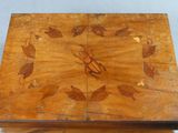 a small wooden box with a design on it