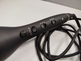 a black hair dryer sitting on top of a table