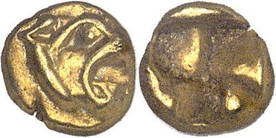 a close up of two gold coins on a white surface