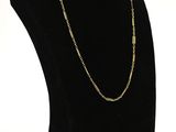 a black mannequin with a gold chain on it