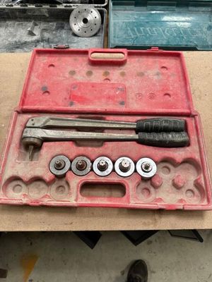 a tool box with a hammer, wrench, and other tools in it