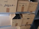 many boxes that are stacked on a shelf in a room