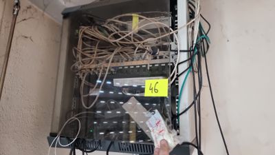 une personne tenant une télécommande devant un serveur