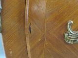 a wooden cabinet with a metal handle on it