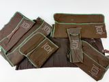 un ensemble de sacs marron et verts posés sur une surface blanche