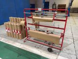 a cart with several rolls of paper on it in a warehouse