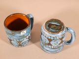 two coffee mugs sitting next to each other on a table