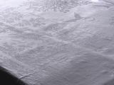 a bed with a white comforter on top of it