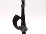 sculpture of a black vase on a stand on a white background