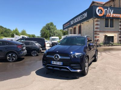 the mercedes gle parked in front of a building with cars parked in front of it