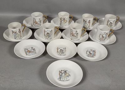 several cups and saucers are arranged on a table with spoons