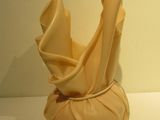 a sculpture of a vase on a white table