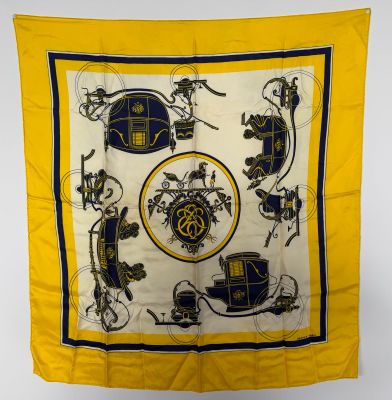 a yellow and black scarf with a picture of a horse and carriage on it
