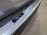 a close up of a car ' s bumper with a sticker on it