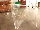 a clear table with a glass top in the middle of a room